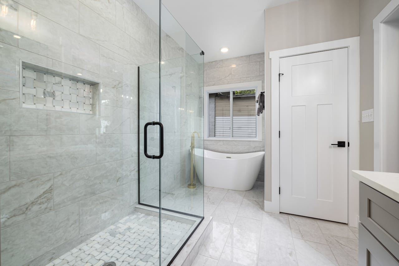 services-02 Bright modern bathroom featuring a glass shower and freestanding bathtub. Perfect for design inspiration.