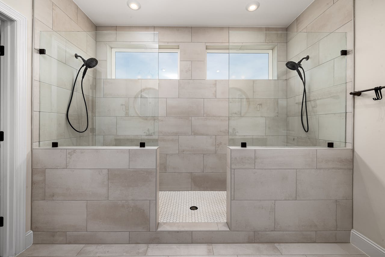 hero-img-01 A sleek, contemporary dual shower bathroom featuring elegant tile work and modern fixtures.