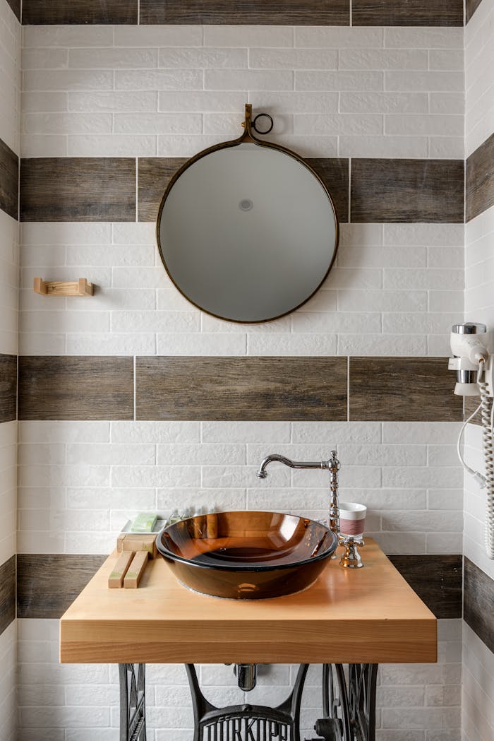 why-choose-us Stylish bathroom interior featuring a modern vessel sink, round mirror, and unique design elements.