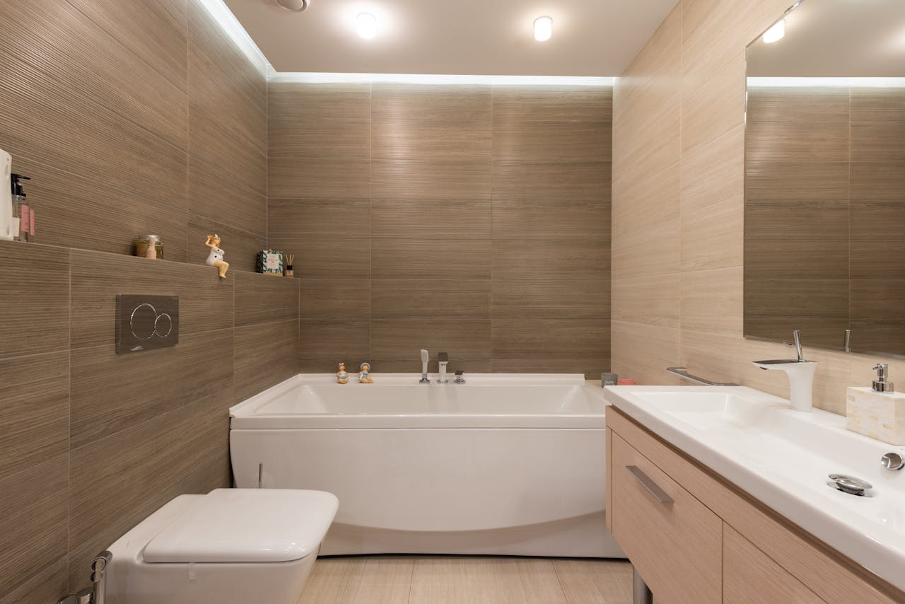 gallery-1 Elegant bathroom featuring modern fixtures and wooden tiles.