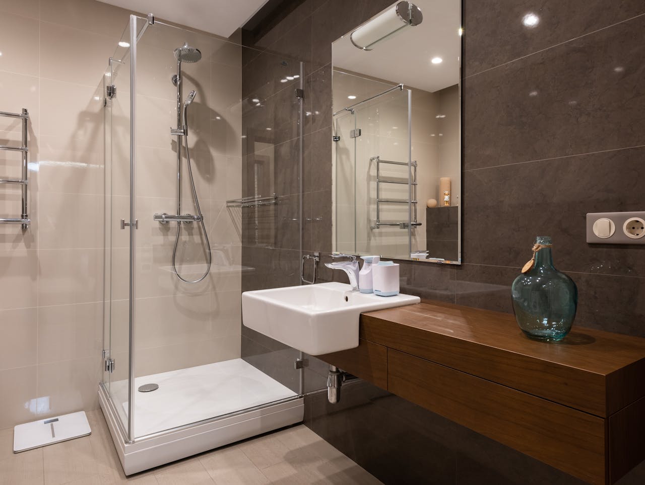 gallery-2 Luxurious contemporary bathroom featuring glass shower and sleek minimal design.